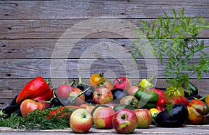 Autumn natural background. Fresh vegetables and fruits are stacked in a pile on a natural wooden background.Harvesting vegetables