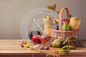 Autumn nature background. Fall fruits and pumpkin on wooden table. Thanksgiving table arrangement