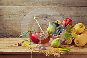 Autumn nature concept. Fall fruits and pumpkin on wooden table. Thanksgiving dinner