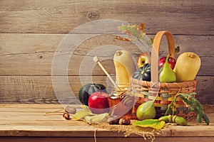Autumn nature concept. Fall fruits and pumpkin on wooden table. Thanksgiving dinner