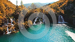 Autumn nature in Plitvice Lakes National Park Croatia. Aerial view of waterfall flows into emerald green fresh water at