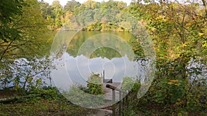 Autumn nature on the shores of the Southern Bug. The calm flow of the river. Reflection in the water of the sky and trees