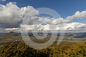 Autumn nature view from mountain to the horizont with hills and mountains and cloudy sky