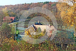 Autumn October rural landscape from hill- home roof, road,  lake and  birch maple forest