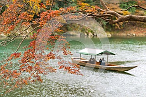 Autumn orange and red, with boats in the background out of focus