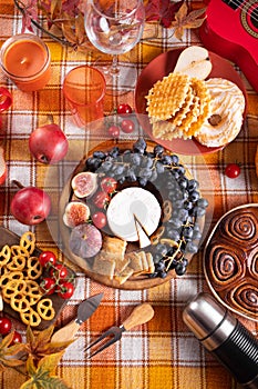 Autumn outdoor picnic set or dinner for celebration Thanksgiving Day. Holiday party. Festive table. Snacks, friuts,pie, vegetables