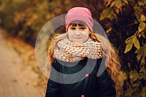 Autumn outdoor portrait of beautiful happy child girl walking in park or forest