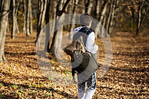 Autumn outdoor portrait of teenager boy with backpack in forest