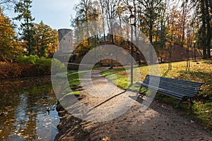 Autumn park with promenade along the lake in Cesis town, Latvia