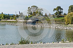 Autumn park with terasse and lake or river