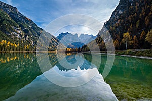 Autumn peaceful alpine lake Durrensee or Lago di Landro.  Snow-capped Cristallo rocky mountain group behind, Dolomites, Italy, photo