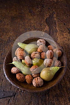 Autumn pears and walnuts in a bowl