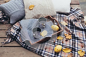 Autumn picnic with two cups of tea in a forest near lake