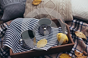 Autumn picnic with two cups of tea in a forest near lake