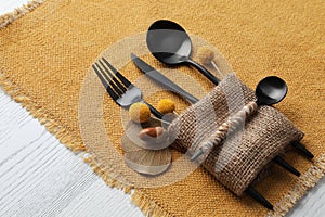 Autumn place setting with cutlery on white table, closeup