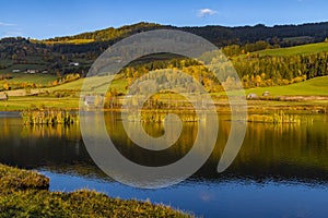 autumn pond under the mountains, Murau district,.Styria, Austria