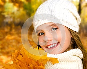 Autumn portrait of adorable little girl in hat