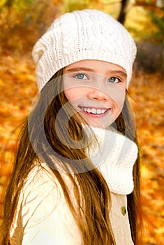 Autumn portrait of adorable little girl in hat