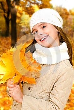 Autumn portrait of adorable little girl in hat