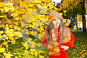 Autumn portrait of beautiful kazakh, asian child. Happy little girl with leaves in the park in fall.