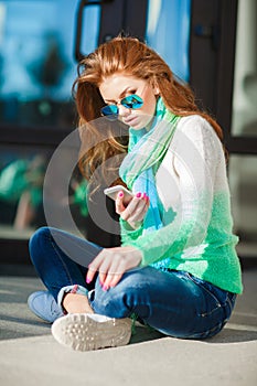 Autumn portrait of girl reading SMS on your phone