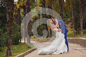 Autumn portrait of happy wedding couple.