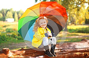 Autumn portrait little girl with colorful umbrella outdoors