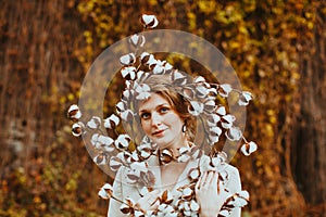 Autumn portrait sensual young woman. Girl holding beautiful cotton flowers