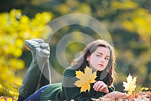 Autumn portrait of young teenage girl relax outdoor. Young pretty teen at park.