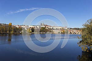 Colorful autumn Prague gothic Castle and Charles Bridge with the Lesser Town in the sunny Day, Czech Republic