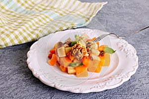 Autumn Pumpkin Apple Salad. Dietary salad with pumpkin, nuts and apples