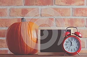 Autumn pumpkin and blackboard menu with alarm clock