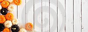 Autumn pumpkin corner border in Halloween colors orange, black and white against a white wood banner background