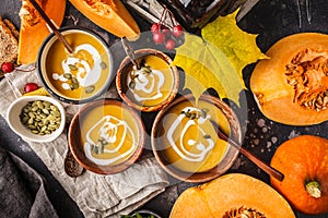 Autumn pumpkin soup puree with cream in cups, the autumn scenery