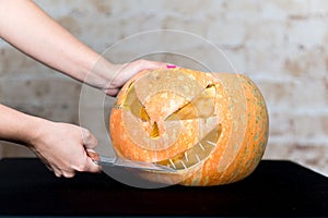 Autumn Pumpkin Thanksgiving Background - orange pumpkins over wooden table. Pumpkin on a black background. Autumn product. Carved