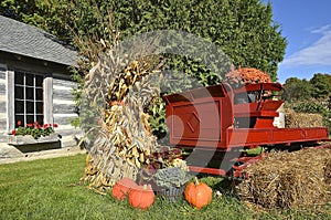 Autumn pumpkins,trailer, and corn shocks photo