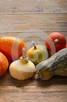 Autumn pumpkins on a wooden thanksgiving table