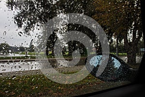 Autumn. Rain. View from the car window. Rearview mirror.