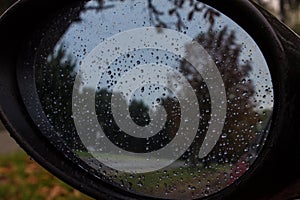 Autumn. Rain. View from the car window. Rearview mirror.