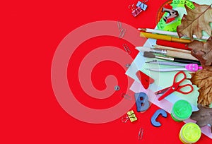 Autumn red background with school stationery, back to school