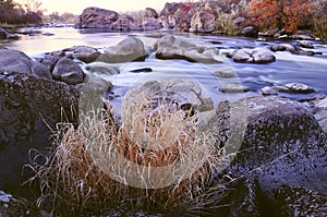 Autumn river with a swift current, rapids, rocks photo