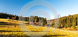 autumn rolling landscape with meadow, few isolated houses, forest and clear sky - Vysni Mohelnice bellow Lysa hora hill