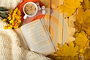 Autumn romance. Book, flowers and aromatic cappuccino