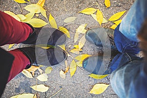 Autumn romance. Legs of man and woman on fallen leaves