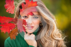 Autumn romance woman with leaves. Female model on foliage day. Dream and lifestyle. Beauty outdoor portrait. Carefree