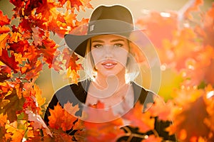 Autumn romance woman with leaves. Female model on foliage day. Dream and lifestyle. Beauty outdoor portrait. Carefree