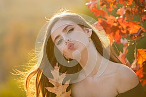 Autumn romance woman with leaves. Female model on foliage day. Dream and lifestyle. Beauty outdoor portrait. Carefree