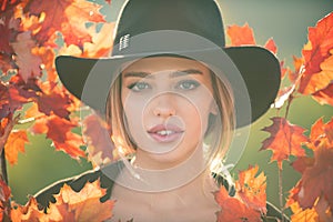 Autumn romance woman with leaves. Female model on foliage day. Dream and lifestyle. Beauty outdoor portrait. Carefree