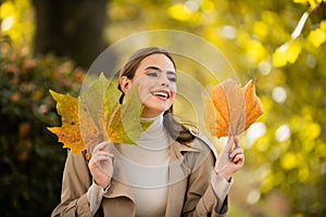 Autumn romance woman with leaves. Female model on foliage day. Dream and lifestyle. Beauty outdoor portrait. Carefree