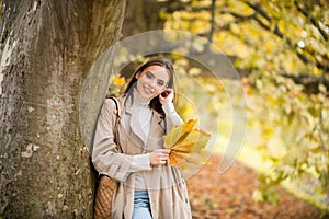 Autumn romance woman with leaves. Female model on foliage day. Dream and lifestyle. Beauty outdoor portrait. Carefree